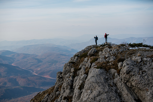 Couple in love standing on top of the mountain