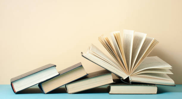 istock Open book, hardback books on wooden table. Education background. Back to school. Copy space for text. 889020604