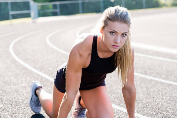 istock Young Female Athlete Working Out on Track 889038660