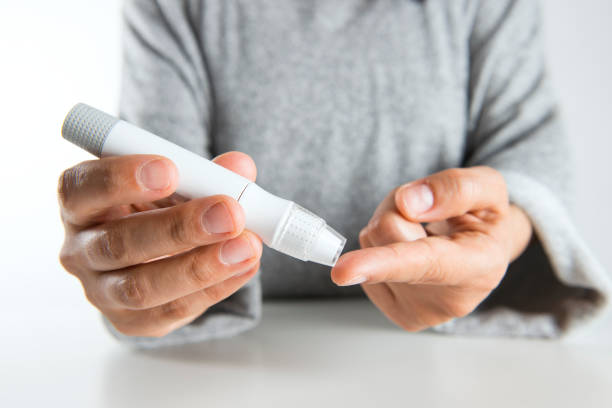istock Woman taking her own blood sugar 889038738