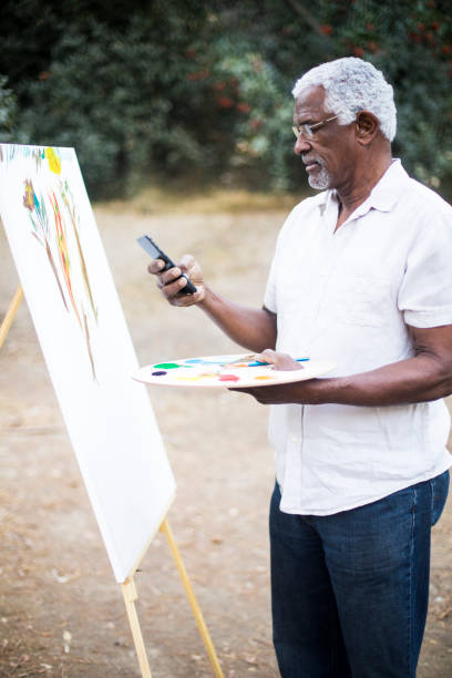 istock Senior African American Man Painting 889045776