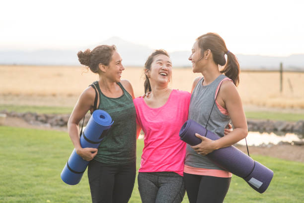 istock Three Women Holding Yoga Mats 889045828
