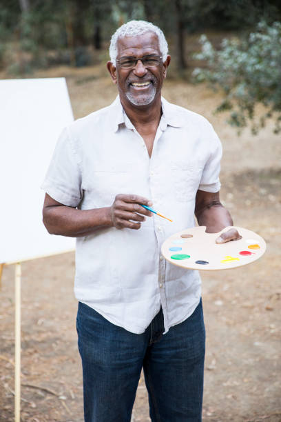 istock Senior African American Man Painting 889046648