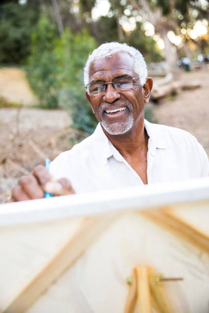 istock Senior African American Man Painting 889048812