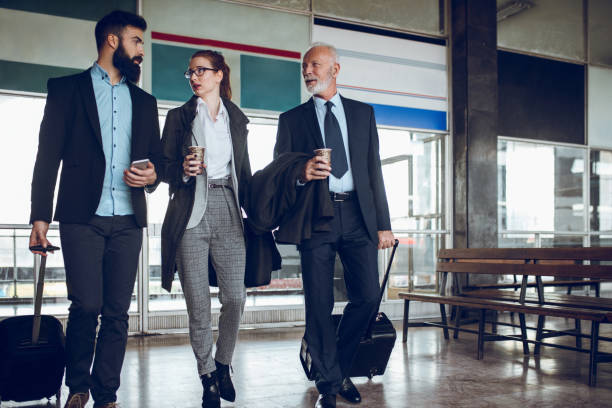 istock Business people with luggage at train station. 889050156