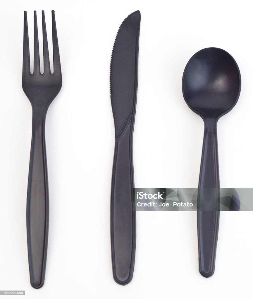 Plstic Utensils Black plastic utensils-fork, knife, and spoon. Vertical. Spoon Stock Photo
