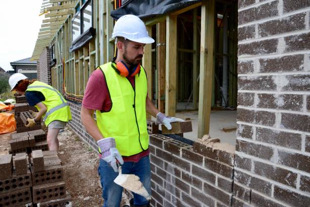 istock SYD112017 Male and female construction workers moving bricks and building 889055716