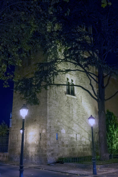 Night view of an old Moorish tower illuminated on a cold December day in Alcala de Henares, Spain