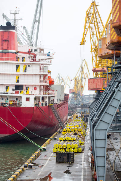 istock Vessel dry cargo on loading, unloading in port. Bulker in port. port terminal. Vessel Balker on loading pipes. Many pipes in port terminal 889058822