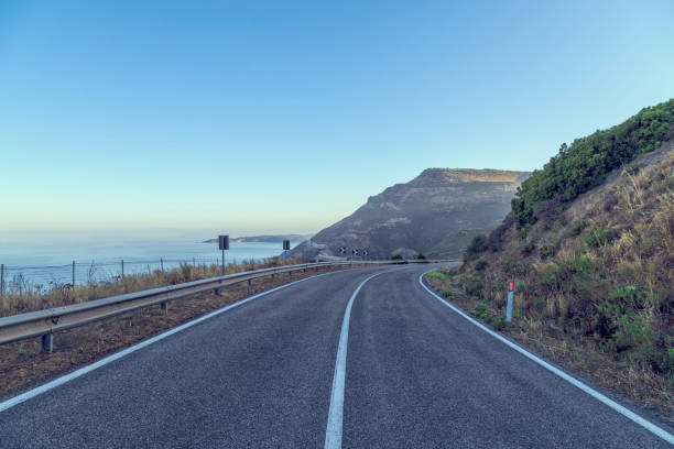 istock Road by the sea with blue sky 889062354