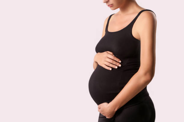 istock Pregnant woman belly - studio shot 889063574