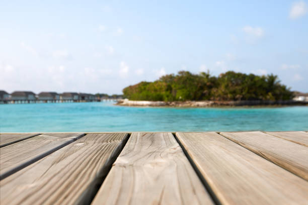 Empty white wood surface over blur blue sea and sky and tropical for product placement and display