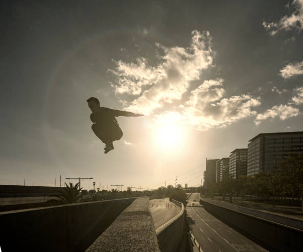 istock Man jumping and practicing parkour in the city 889068586