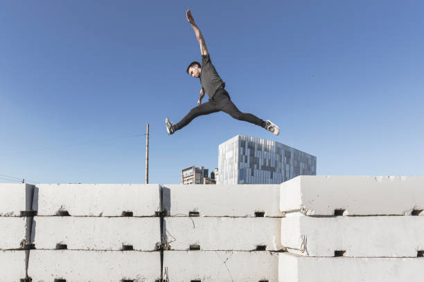 Young man practicing free running in the city