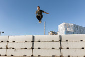 Man jumping and practicing parkour in the city