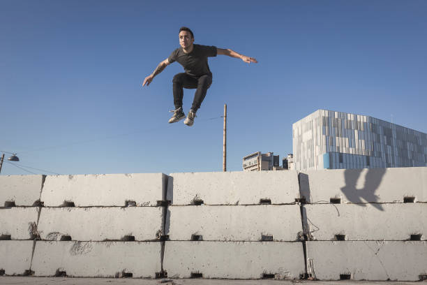 istock Man jumping and practicing parkour in the city 889068626