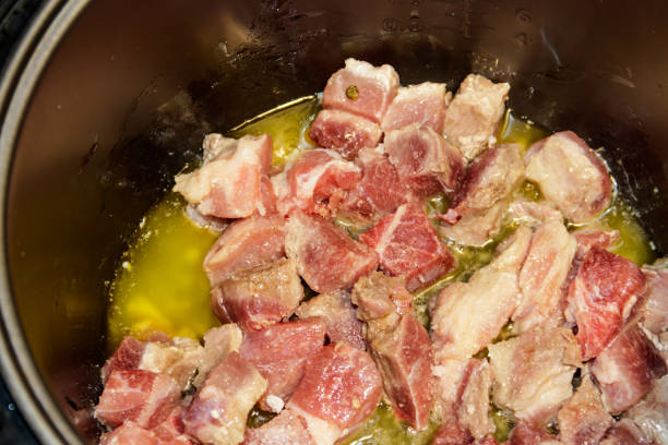 istock Chopped pork meat cooking in slow cooker 889068724