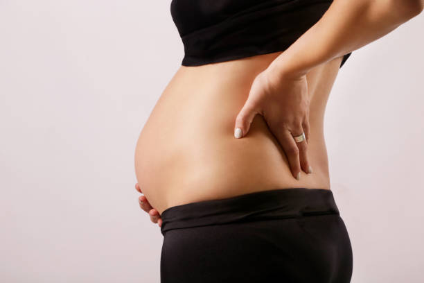 istock Pregnant woman with back pain 889072246