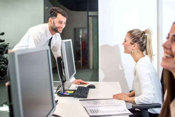 istock Young smiling secretary assisting businessman in office. 889072426