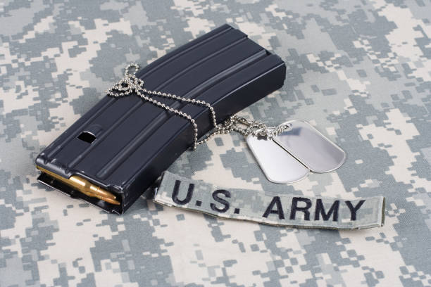 istock M-16 magazine with ammo on camouflage US Army uniform 889082446