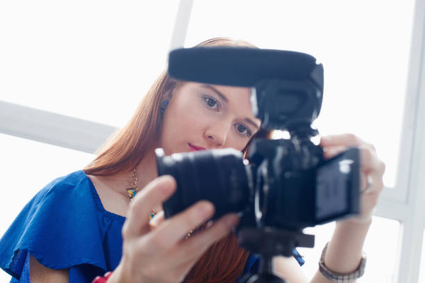 istock Woman Recording Vlog Video Blog Using DSLR Camera 889083794