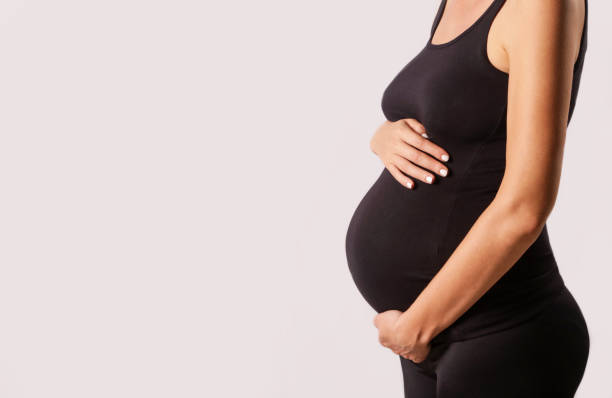 istock Pregnant woman belly - studio shot 889083832