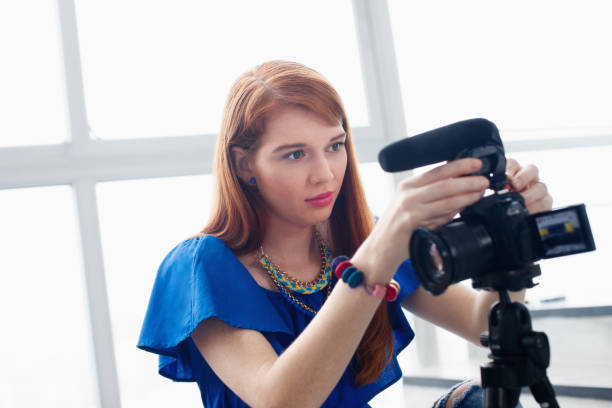 istock Woman Recording Vlog Video Blog Using DSLR Camera 889084274