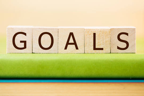 istock Goals written in wooden cubes on a green book 889089302