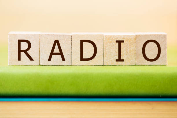 istock Radio written in wooden cubes on a green book 889089374