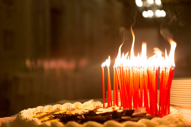 istock Birthday cake with burning candles 889090358