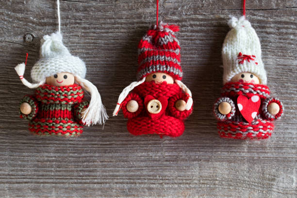 istock Christmas and winter background with copy space - three cute figures in warm hats and sweaters 889095112
