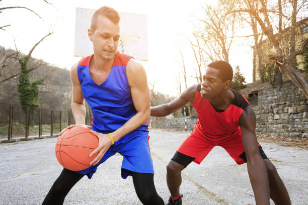 istock Basketball players playing outdoors on court 889102038