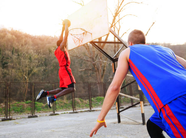 istock African basketball player slam dunking 889102042
