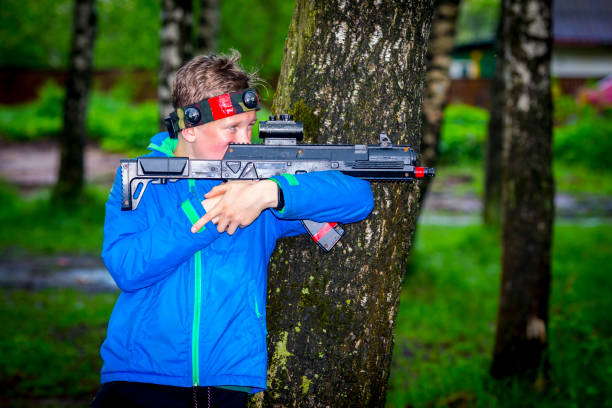 istock Boy with a gun playing laser tag 889108240