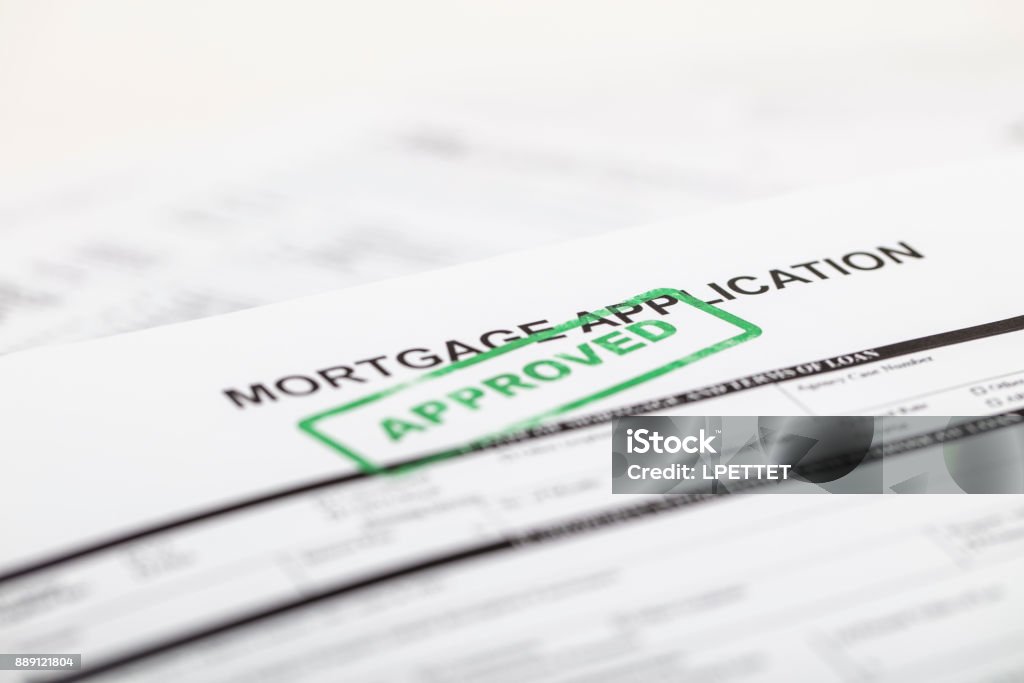 Mortgage Application A stock photo of a Mortgage application form with a green "approved" ink stamp Mortgage Document Stock Photo