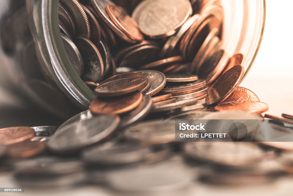 US Coins A stock photo of USA coins overflowing from a mason jar. Jar Stock Photo