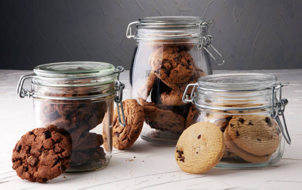 istock Chocolate cookies in a glass jar on white background 889129052