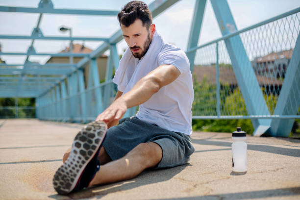 istock Young man exercising outdoors 889136972