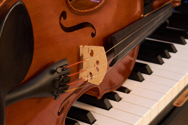 istock Violin close-up on a piano 889144218