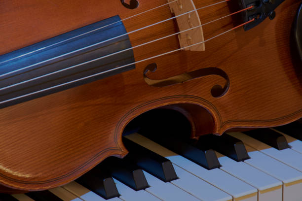 istock Close-up violin on piano 889144242