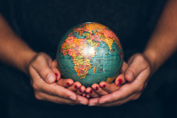 Man's and Woman's hands holding Earth