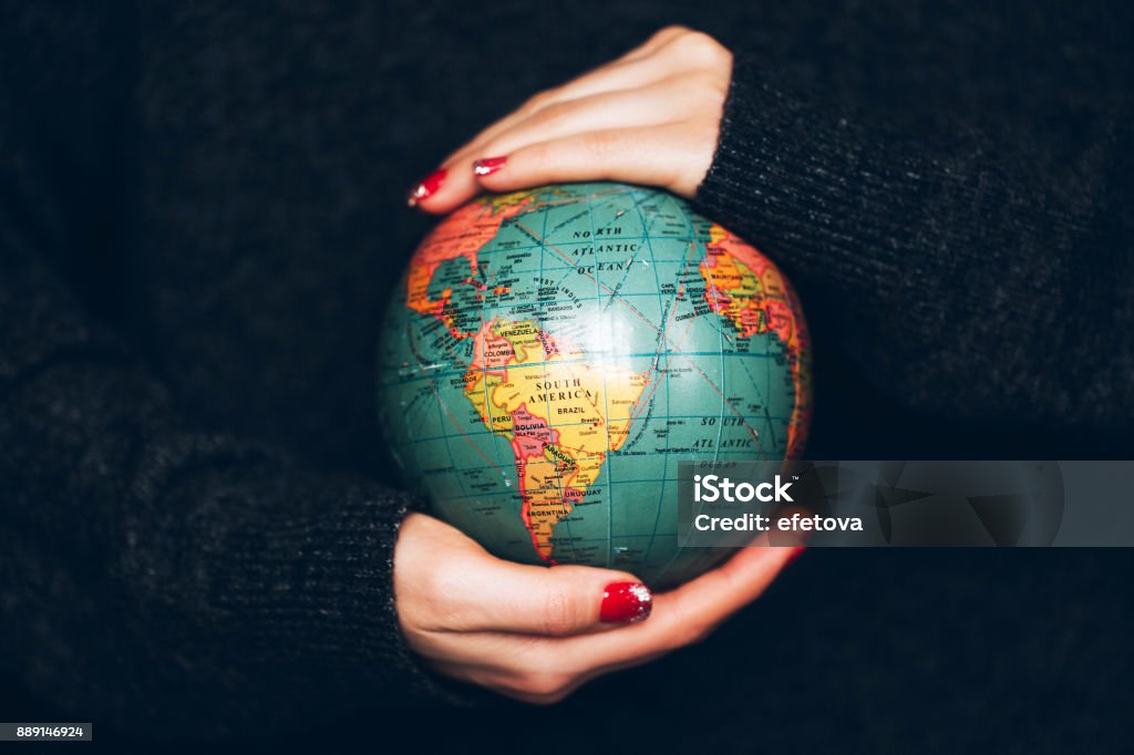 Woman's hands holding Earth. Woman's hands holding Earth. Ecology and saving planet concept. Globe - Navigational Equipment Stock Photo