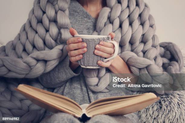 Cozy Woman Covered With Warm Soft Merino Wool Blanket Reading A Book Relax Comfort Lifestyle Stock Photo - Download Image Now