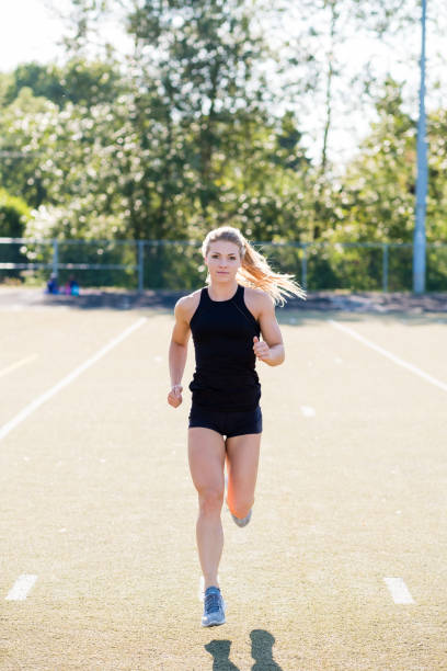 istock Young Female Athlete Working Out on Track 889151798