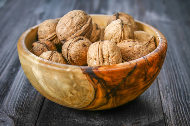 istock Shell and walnut bones on a brown wooden table. 889155060