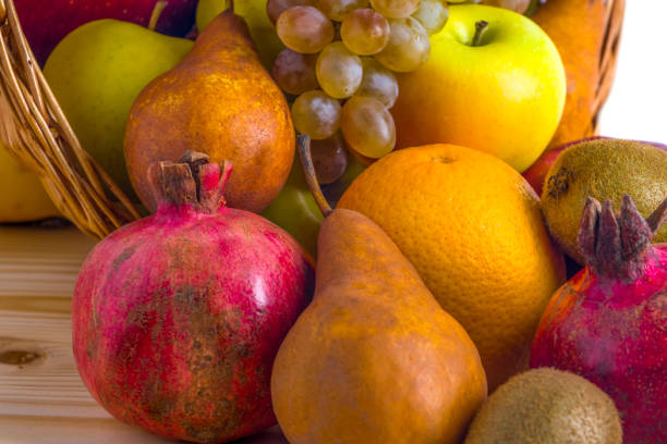 Autumn leaves, quince and pomegranate. Ripe organic pomegranate and quince in still life with yellow leaf. Seasonal background texture. Autumn foliage wallpaper. Fruits pattern.