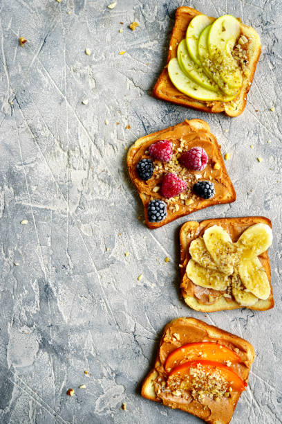 istock Toasts with peanut butter,nuts and fruits 889168632