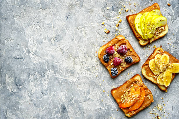 istock Toasts with peanut butter,nuts and fruits 889168674