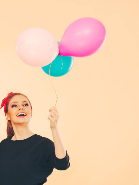 istock Smiling crazy girl having fun with balloons. 889168780