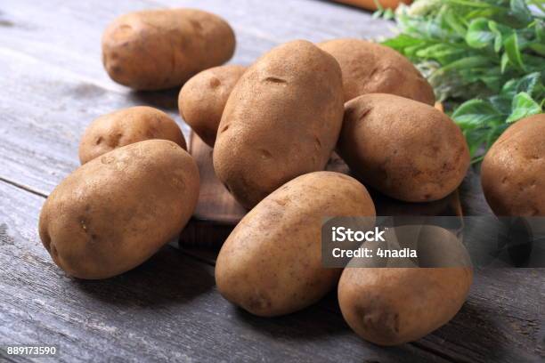 Potatoes On Wooden Table Stock Photo - Download Image Now - Prepared Potato, Raw Potato, Wood - Material